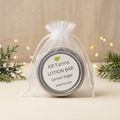 Lemon Sugar lotion bar with warm holiday lights and evergreen accents